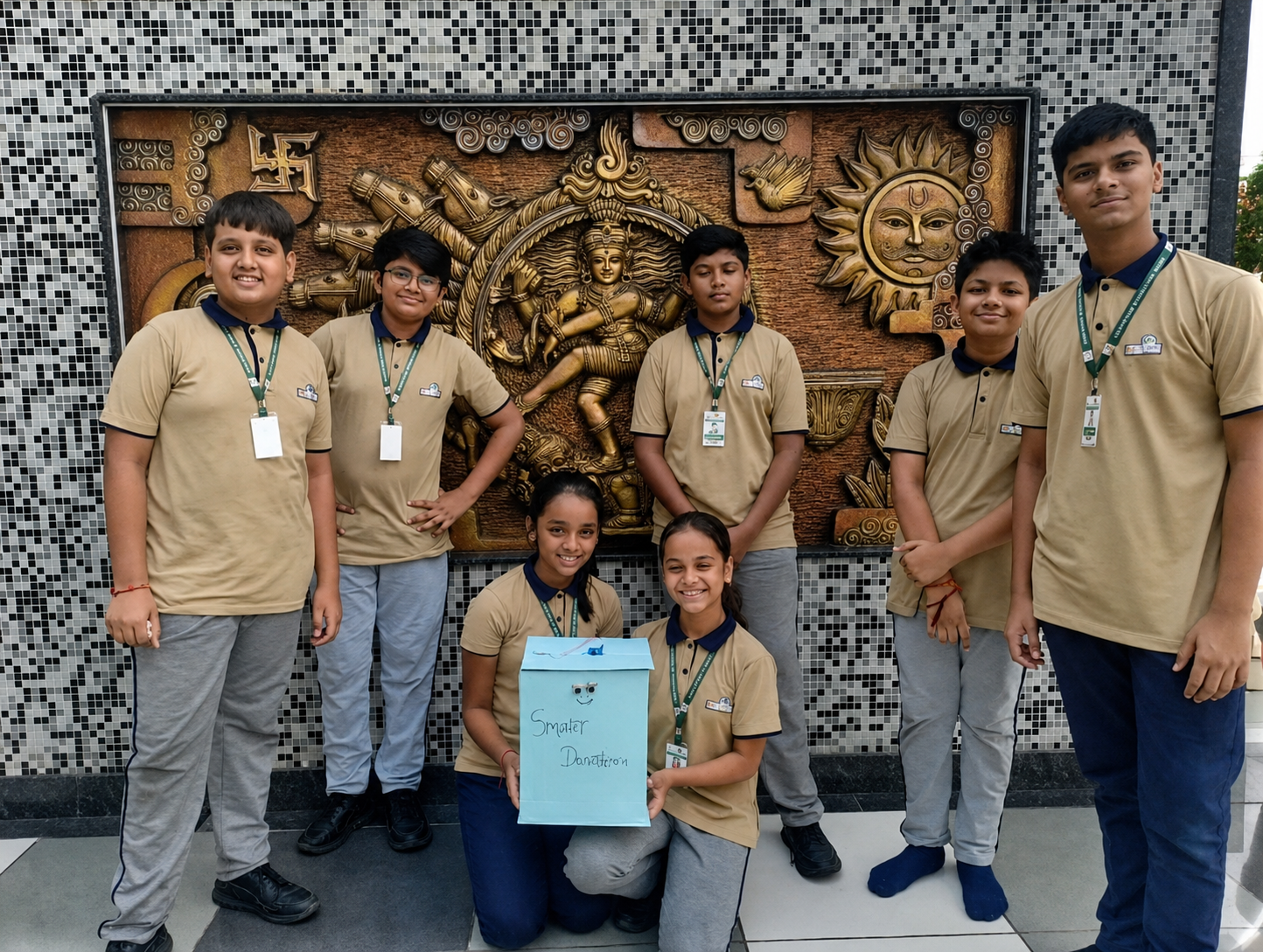 Edusmart students presenting their Smart Dustbin automation project with certificate tags